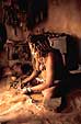 Himba woman making jewelry