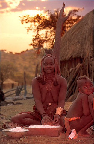 Woman grinding flower at sunrise