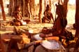 Young Himba women grinding maize in evening sun