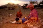 Herero woman cooking breakfast 