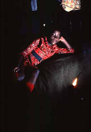 Linda with oil lamp in bed