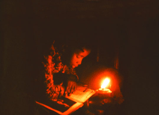 Reading in the glow of the kerosene lamp
