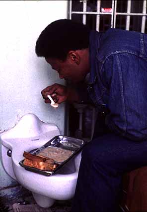 Prisoner eating on toilet