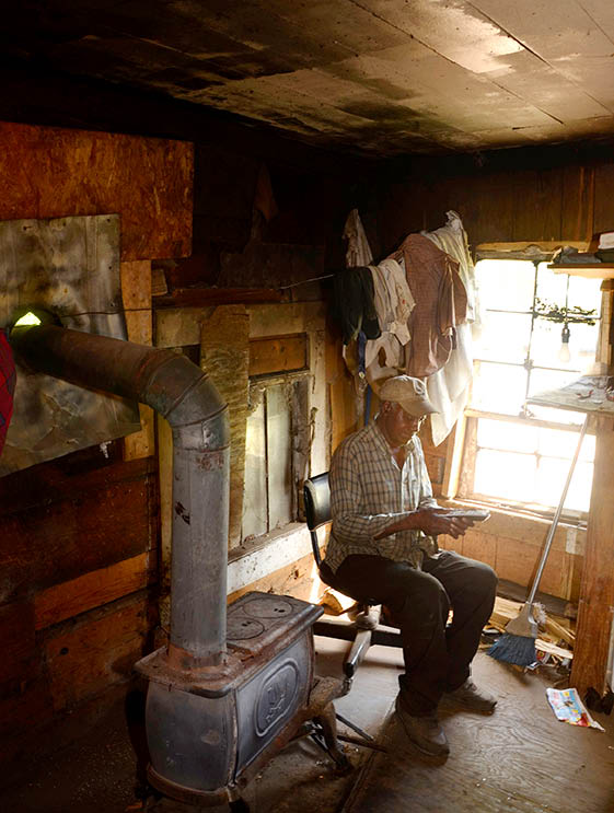 2012 - Old man with cell phone in his shack, Perry County, AL 