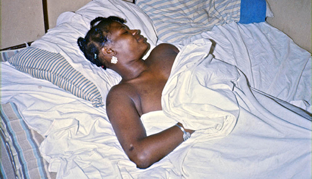 Mary at night in her shack on the forest backroads in Bullock County, 1974 