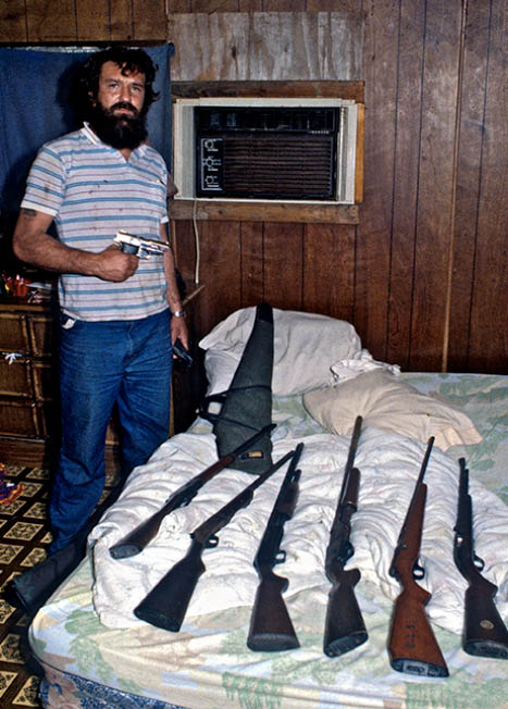 John showing me some of his gun collection on children's bed