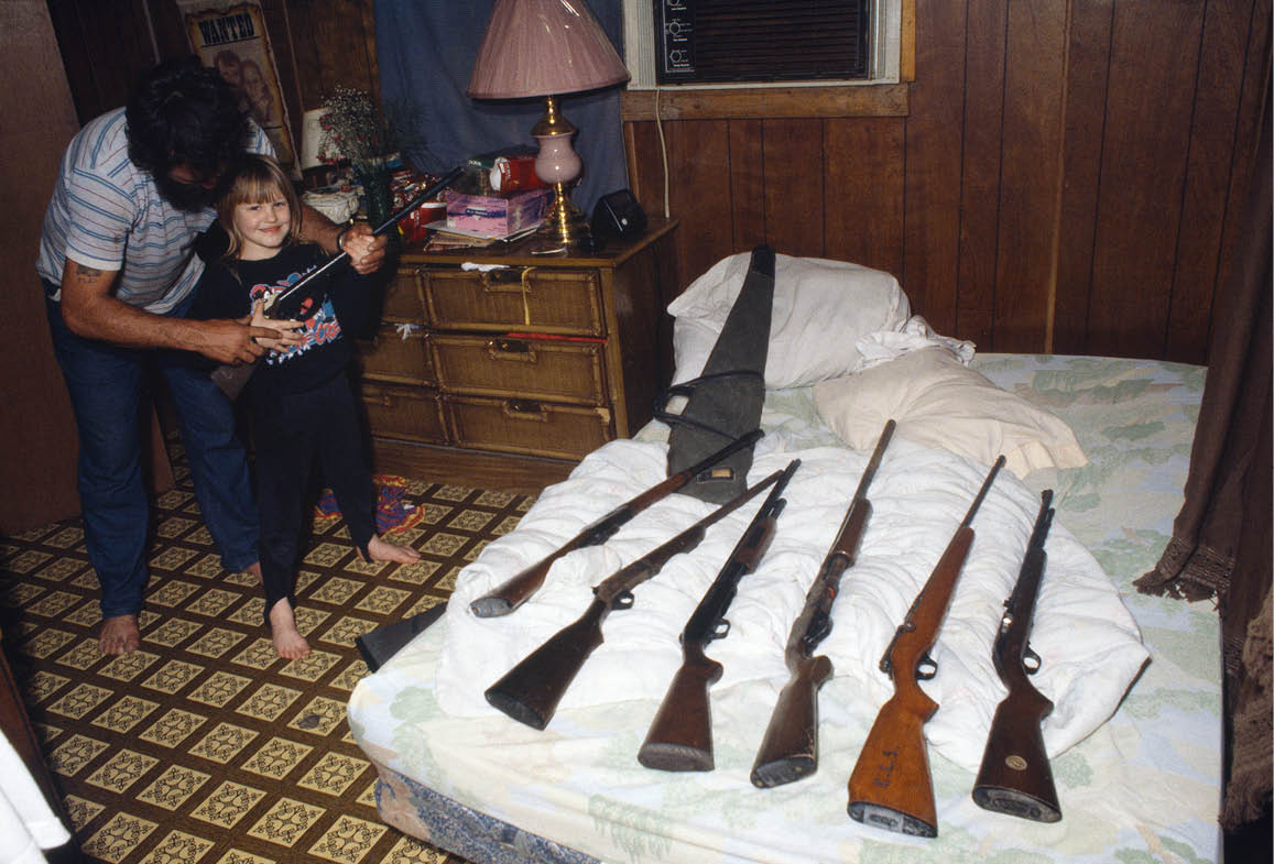 John teaching 7 year old Natasha how to use guns