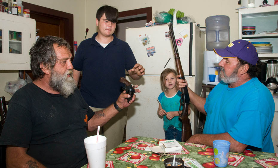 John with his stepson and grandchild Connie showing the guns he used for the killing the night before