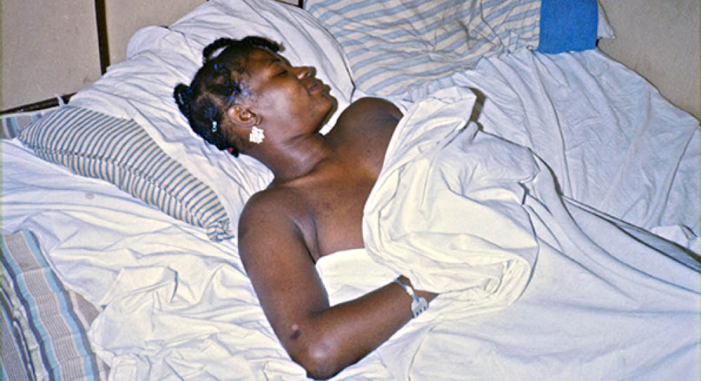 Mary at night in her shack on the forest backroads in Bullock County, 1974 